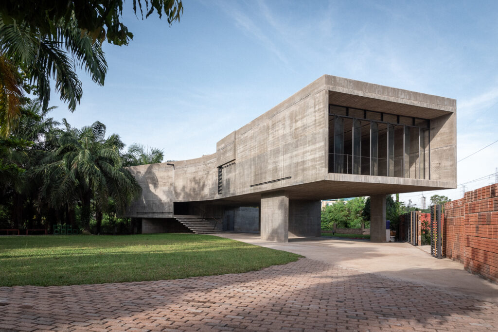 An image of Nubuke Foundation in Accra, Ghana. It is a concrete building set in a tropical garden